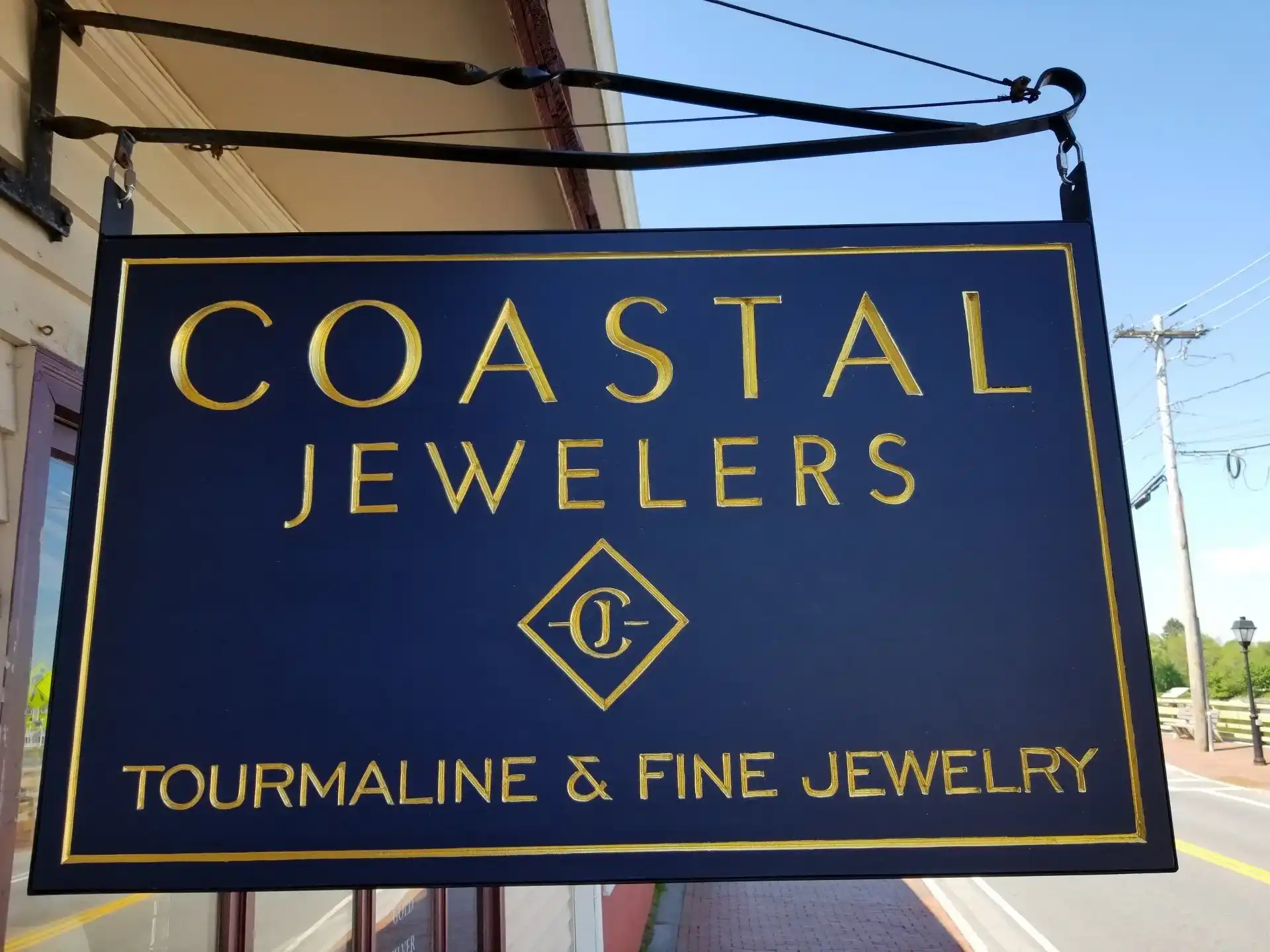 Coastal Jewelers navy and gold rectangular sign