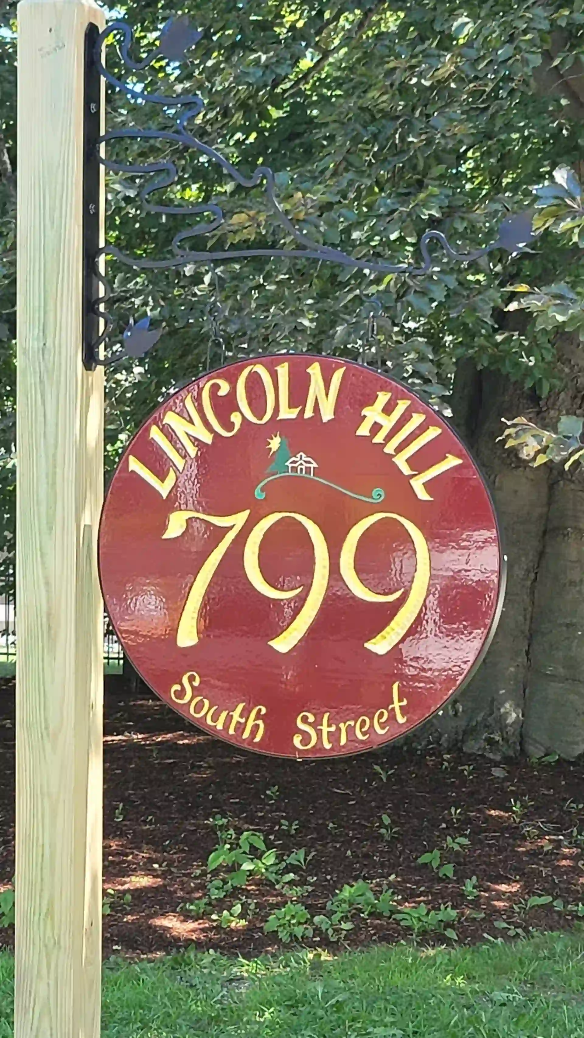 Round carved residential property sign reading Lincoln Hill